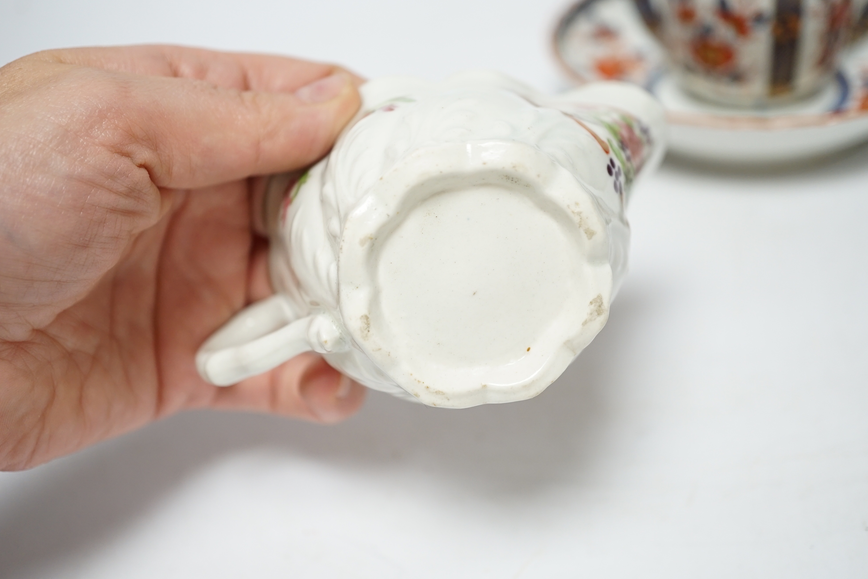 A Worcester ‘low Chelsea ewer’ milk jug, c.1770 and a Worcester Japan pattern coffee cup and saucer, c.1780, jug 6.5cm